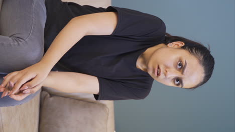 Vertical-video-of-Young-woman-looking-at-camera-with-cowardly-eyes.